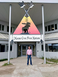 Image of Joel Sherlock in front of the Moose Cree First Nation